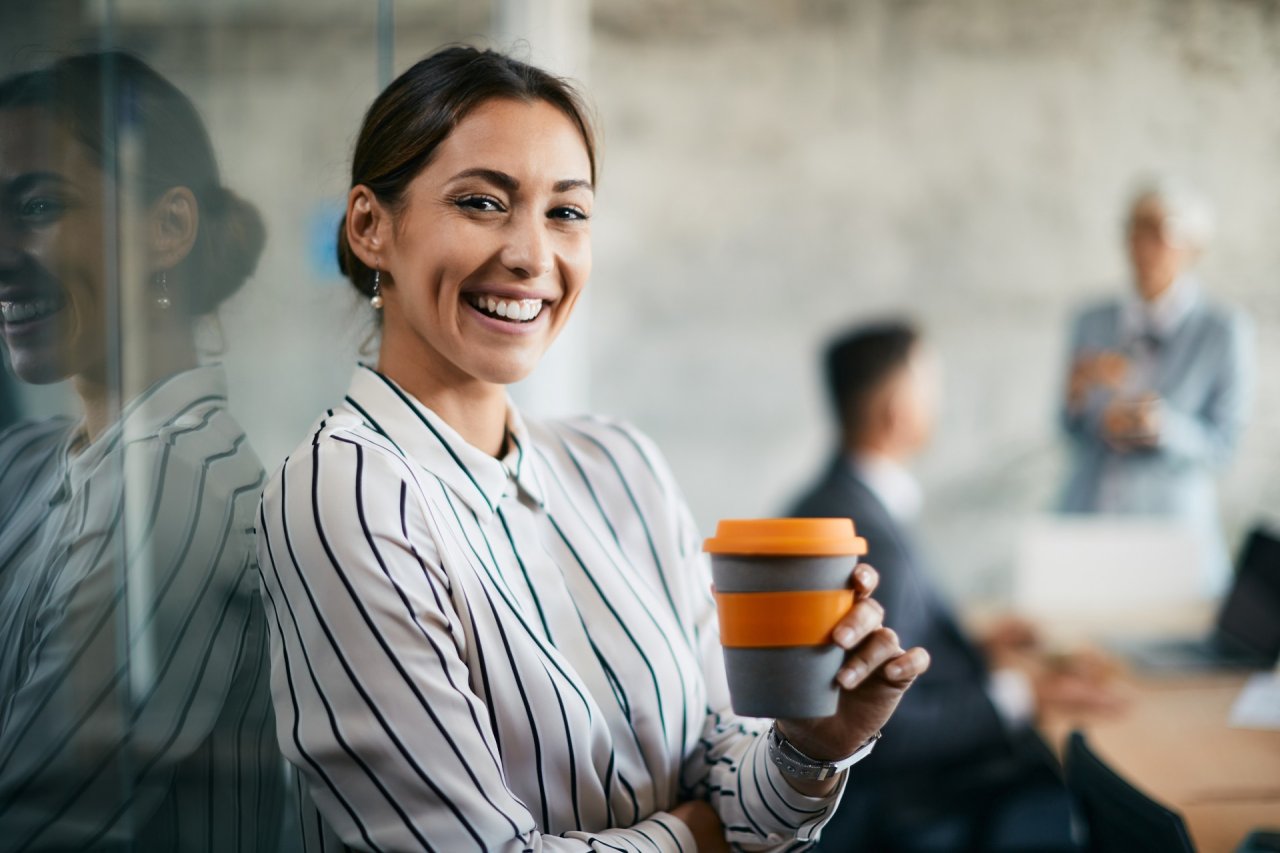 Indian woman smiling, leader at work.